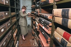 Librarian Working in the Archives with Historic Documents