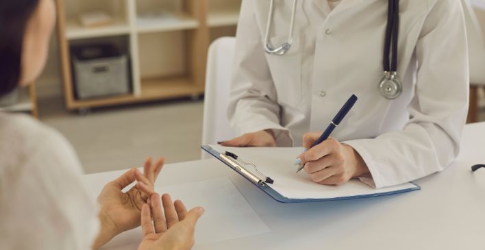 Doctor writing on a clipboard