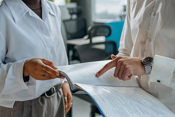 two people pointing to a report