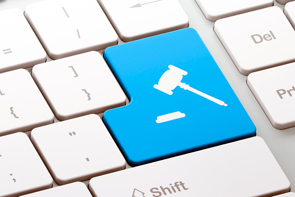 Computer keyboard section that showing the enter key with a judge's gavel on it