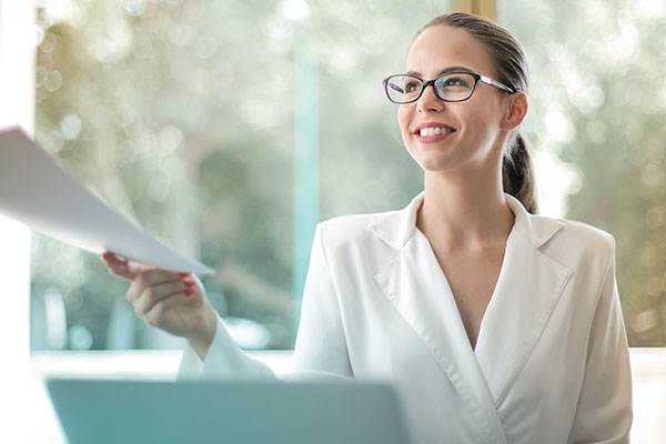 woman handing someone files