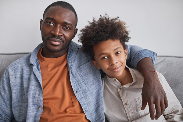 Man sitting on sofa with his teen