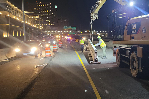 Construction crew installing temporary barrier for Stage 1 construction on I-91SB