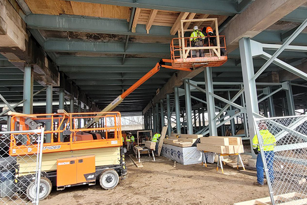 Image of lagging being installed under the bridge in advance of demolition