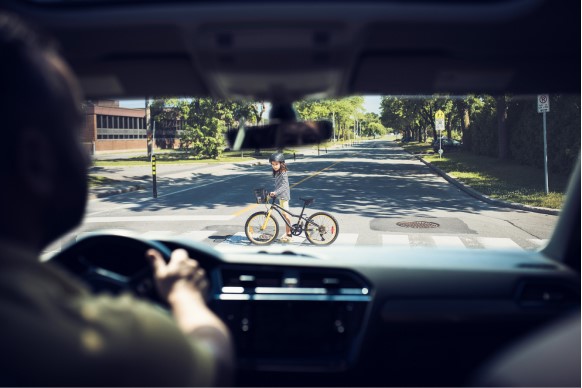 a driver yielding to a pedestrian cyclist - pedestrian safety