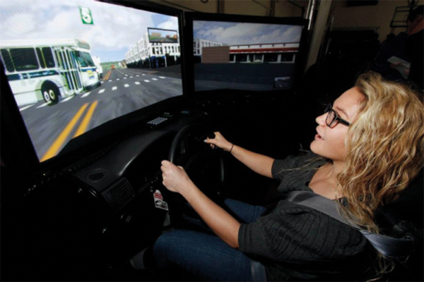 women driving a virtual driving simulation - save a life