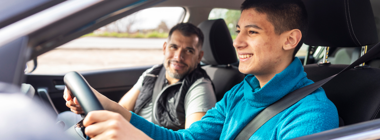 teenage boy driving a car with supervision of another adult