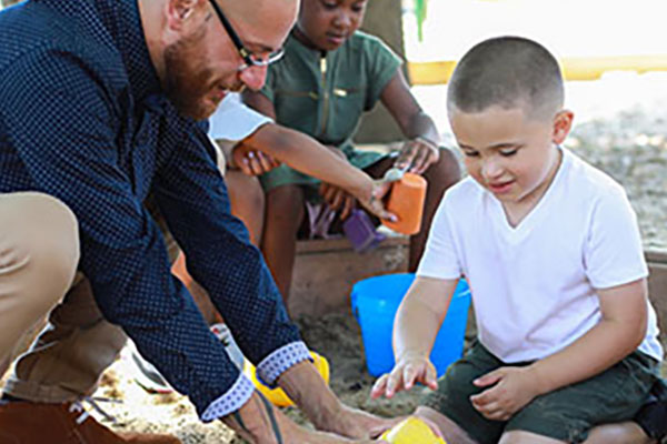 kids in playground with counselor