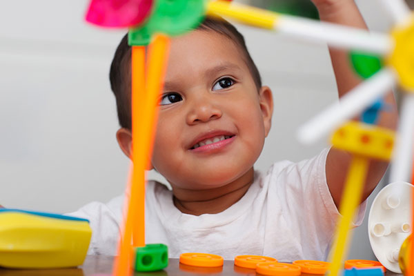 toddler with tinker toy