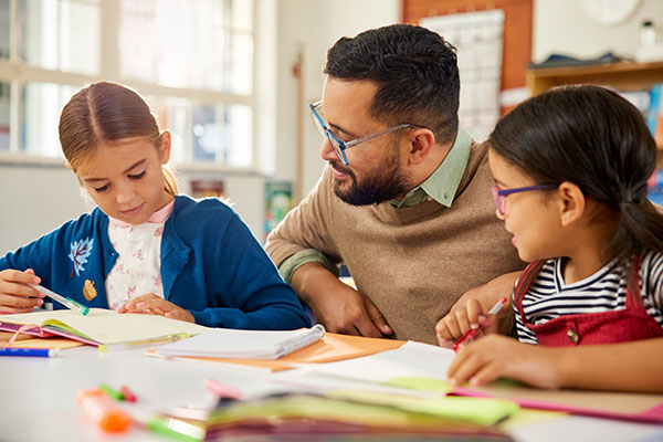Male teacher with two girls