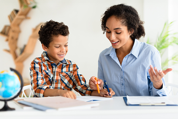 A teacher and student working on an assignment.