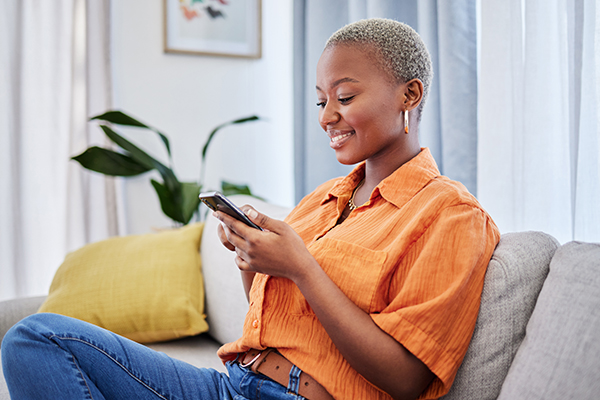 A young adult looking up information on a mobile phone.