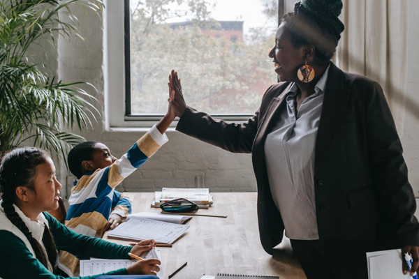 teacher giving her student a high five