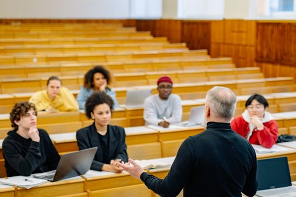 male teacher speaking to students