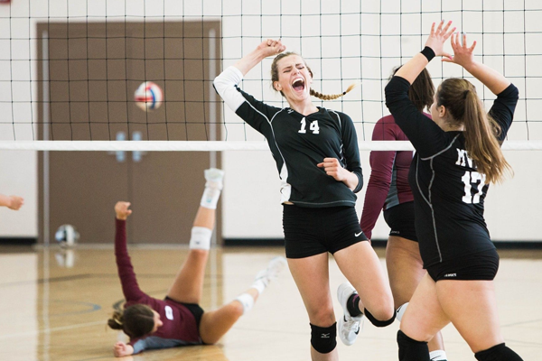 female volleyball players high fiving each other