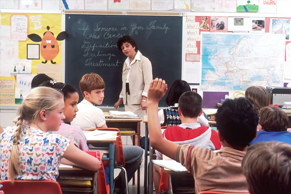 Woman teacher instructing young students