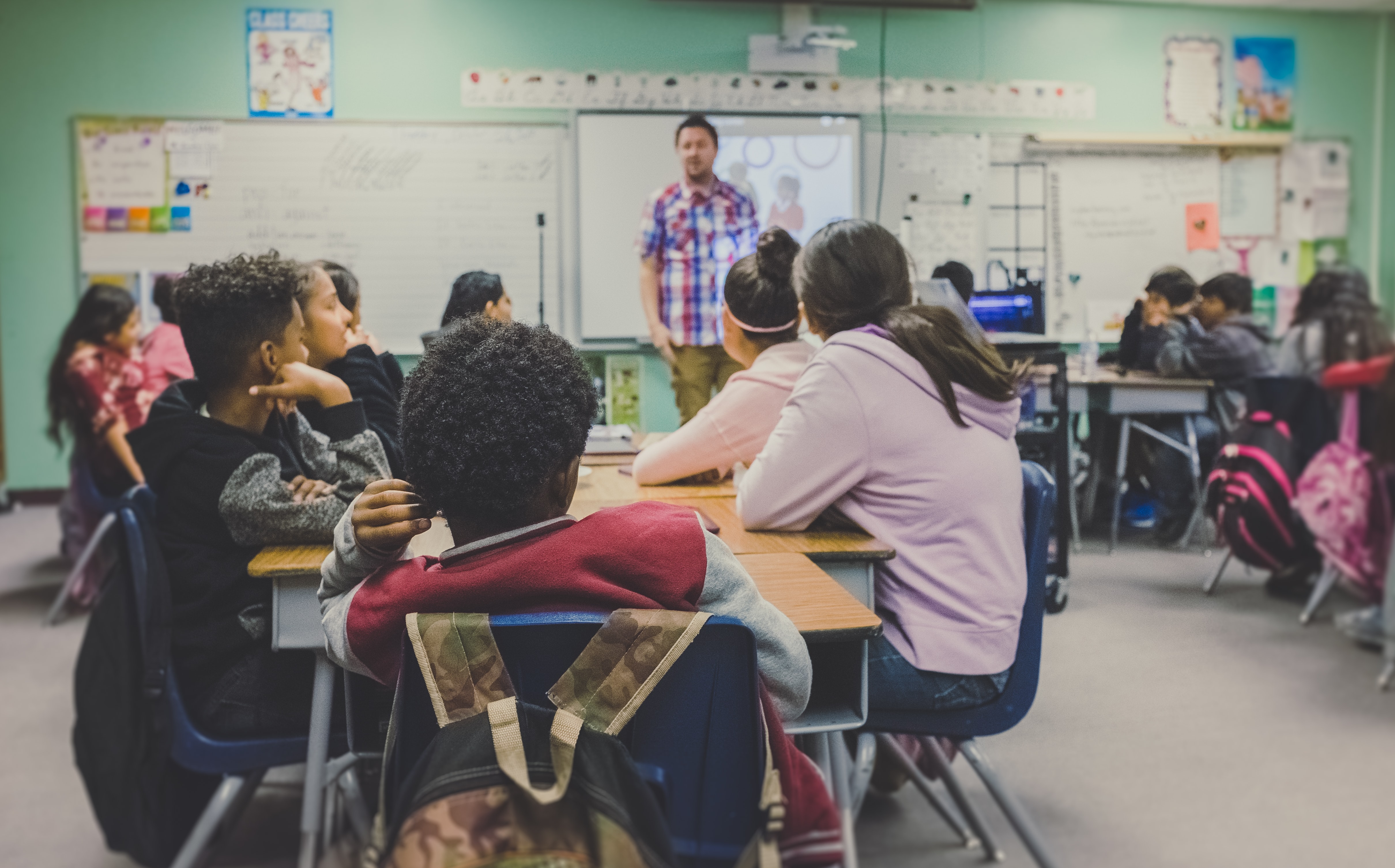 Teacher instructing a classroom of students