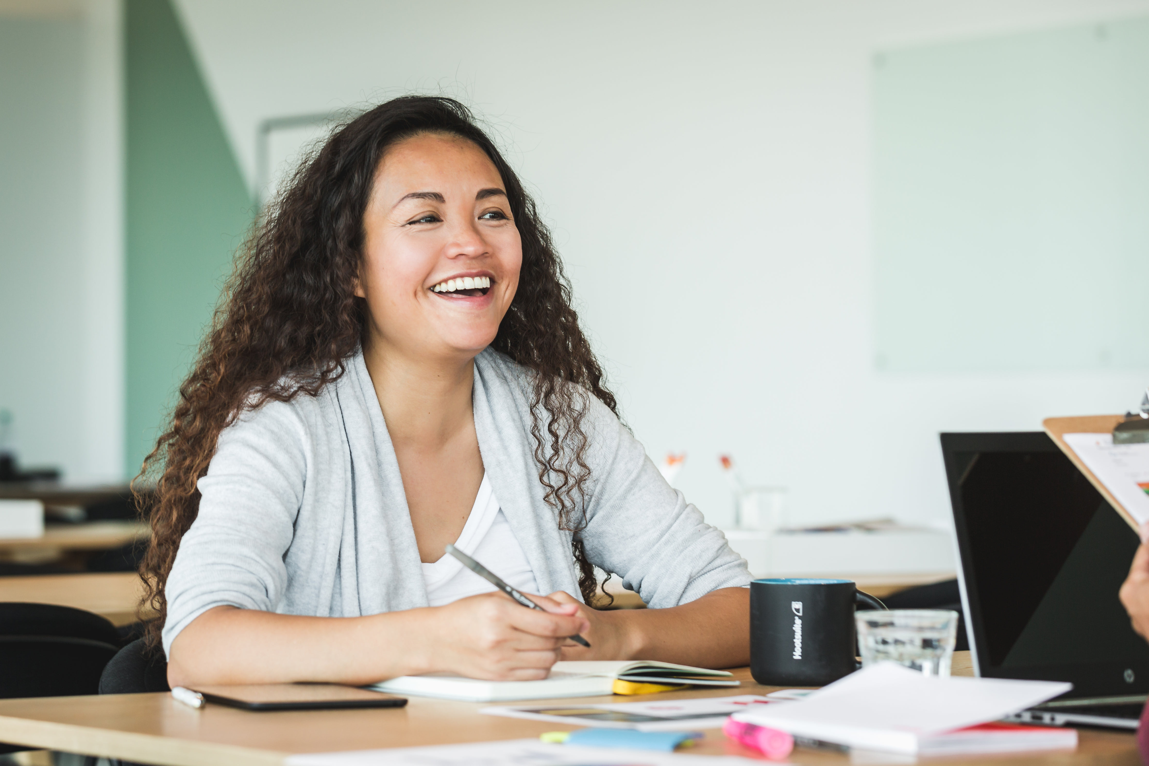 Smiling teacher talking with colleague