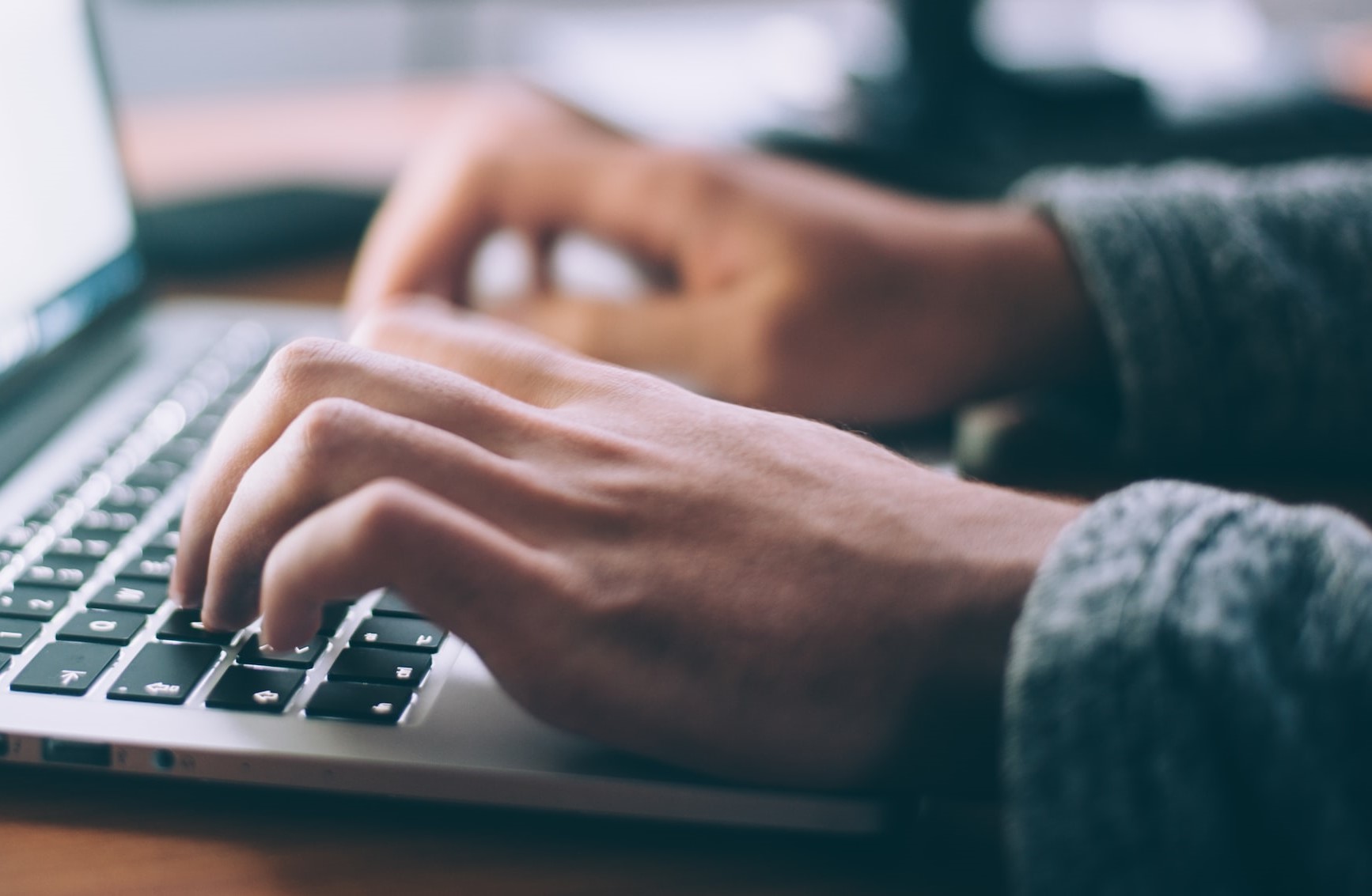 Closeup of person typing on a laptop computer